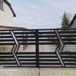 Modern black metal driveway gate with horizontal slats and geometric design in London